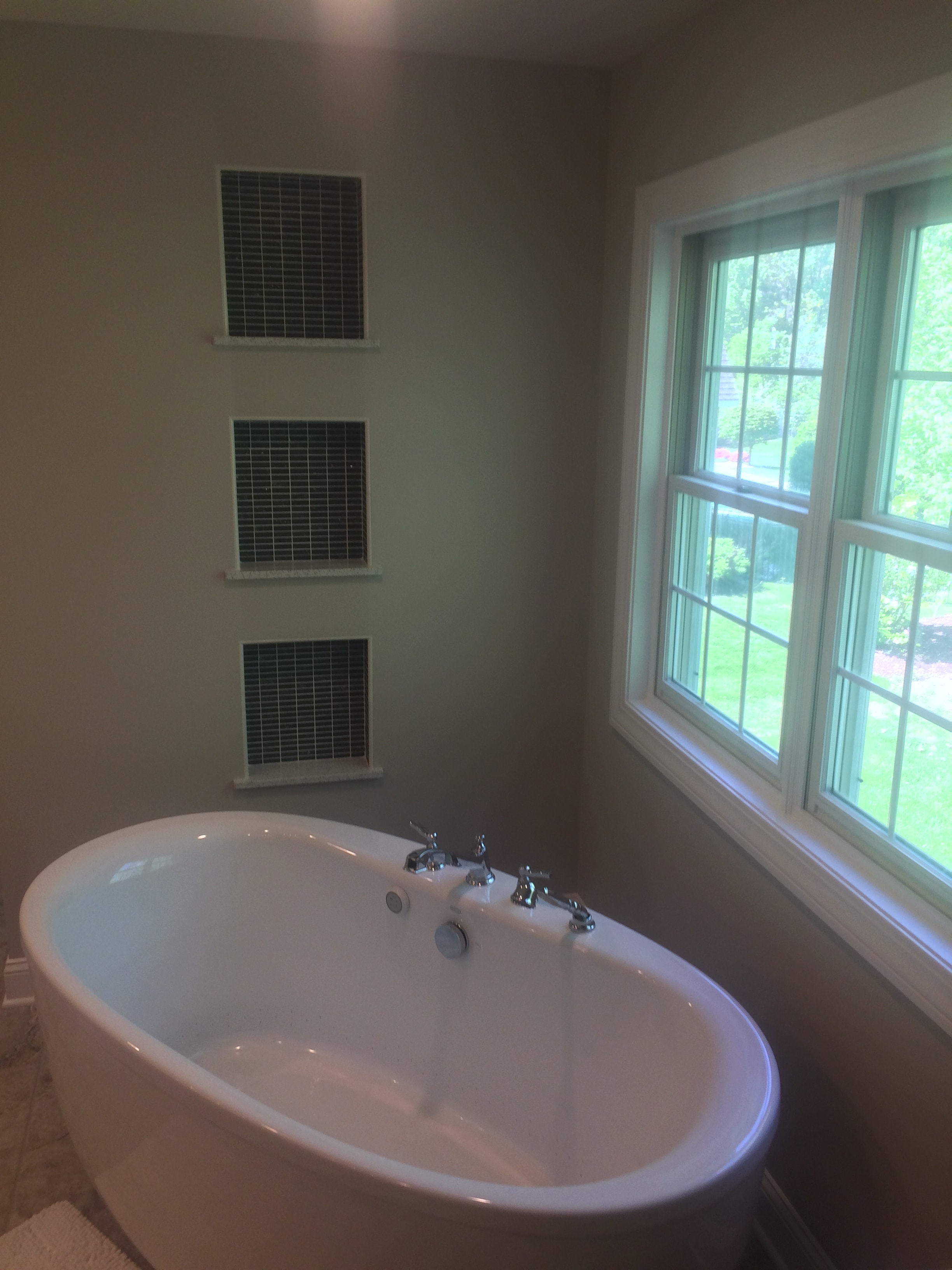 Niskayuna bathroom remodel - freestanding soaking tub under large skylight with chrome fixtures