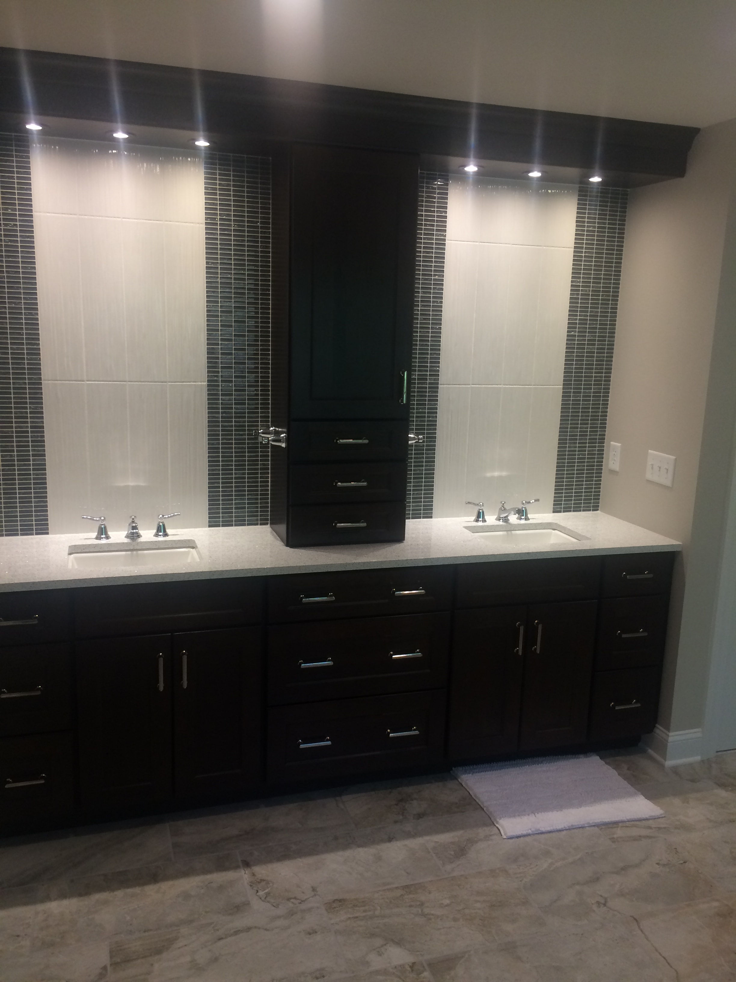 Niskayuna bathroom remodel - dual vanity with dark espresso cabinetry, two sinks, and travertine floor