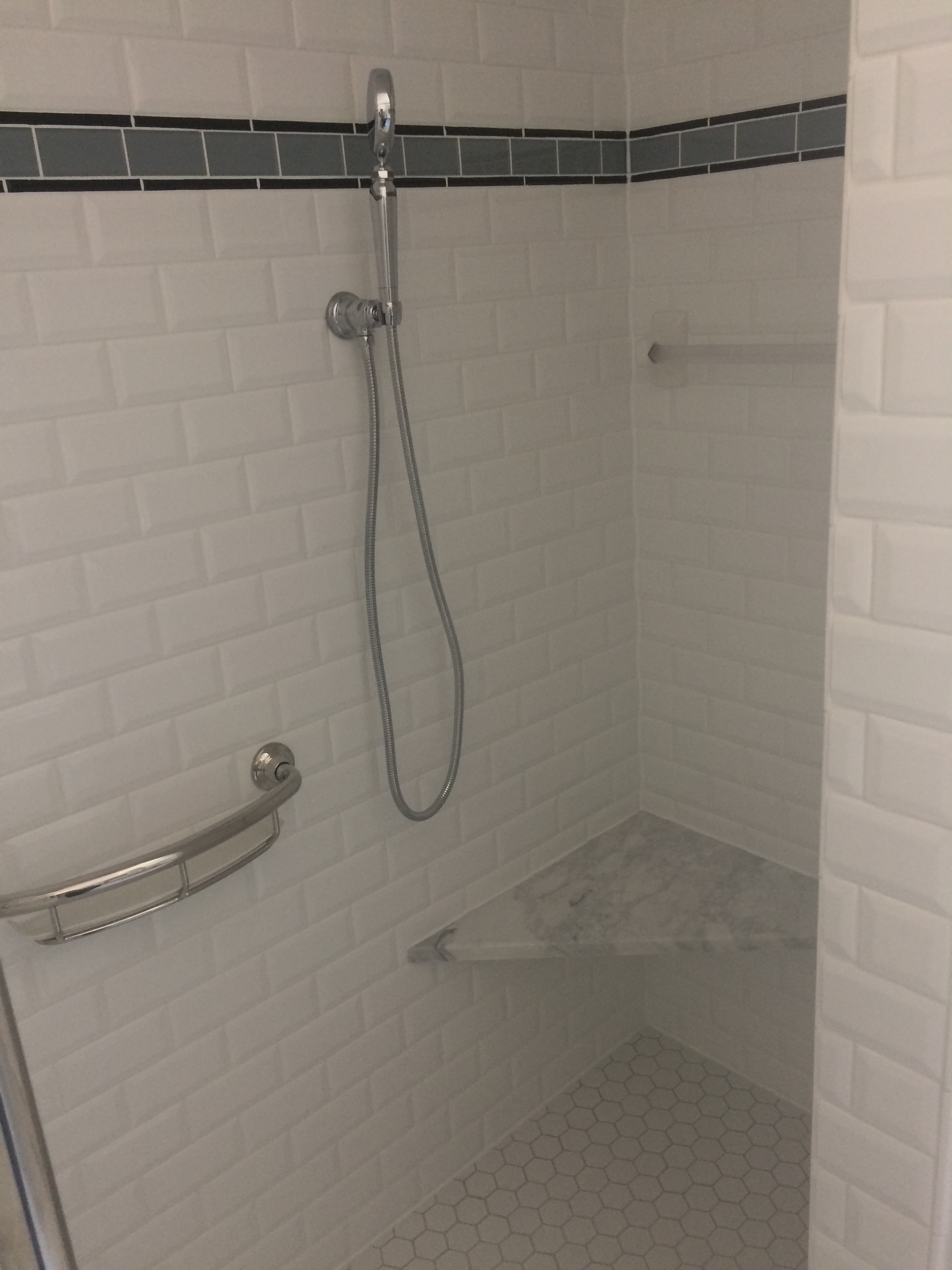 Niskayuna 2 bathroom remodel - shower interior with white subway tile, slate blue accent stripe, and grab bars
