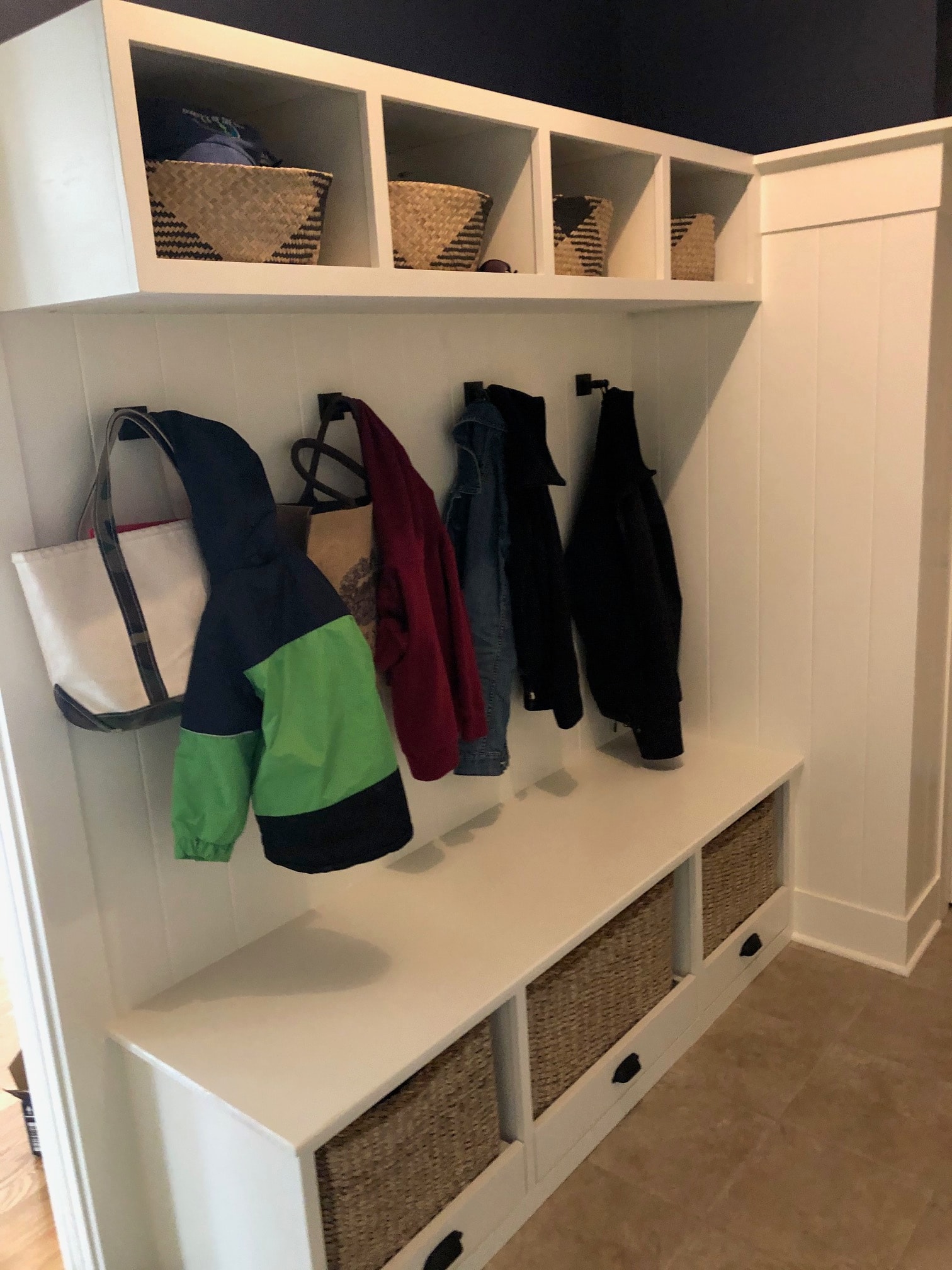 Altamont mudroom built-in bench cubby storage detail with woven baskets and open compartments