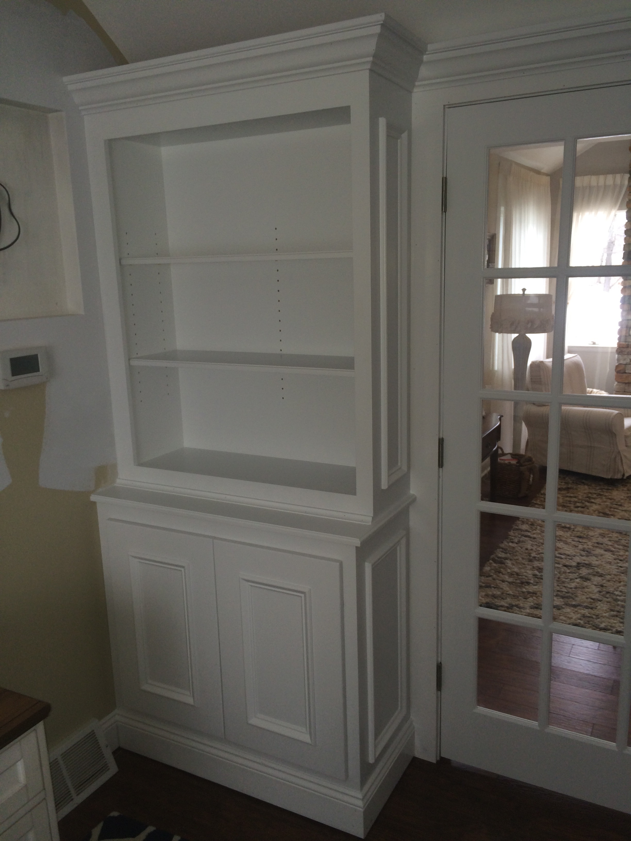 Loudonville built-ins lower raised panel cabinet detail below French doors