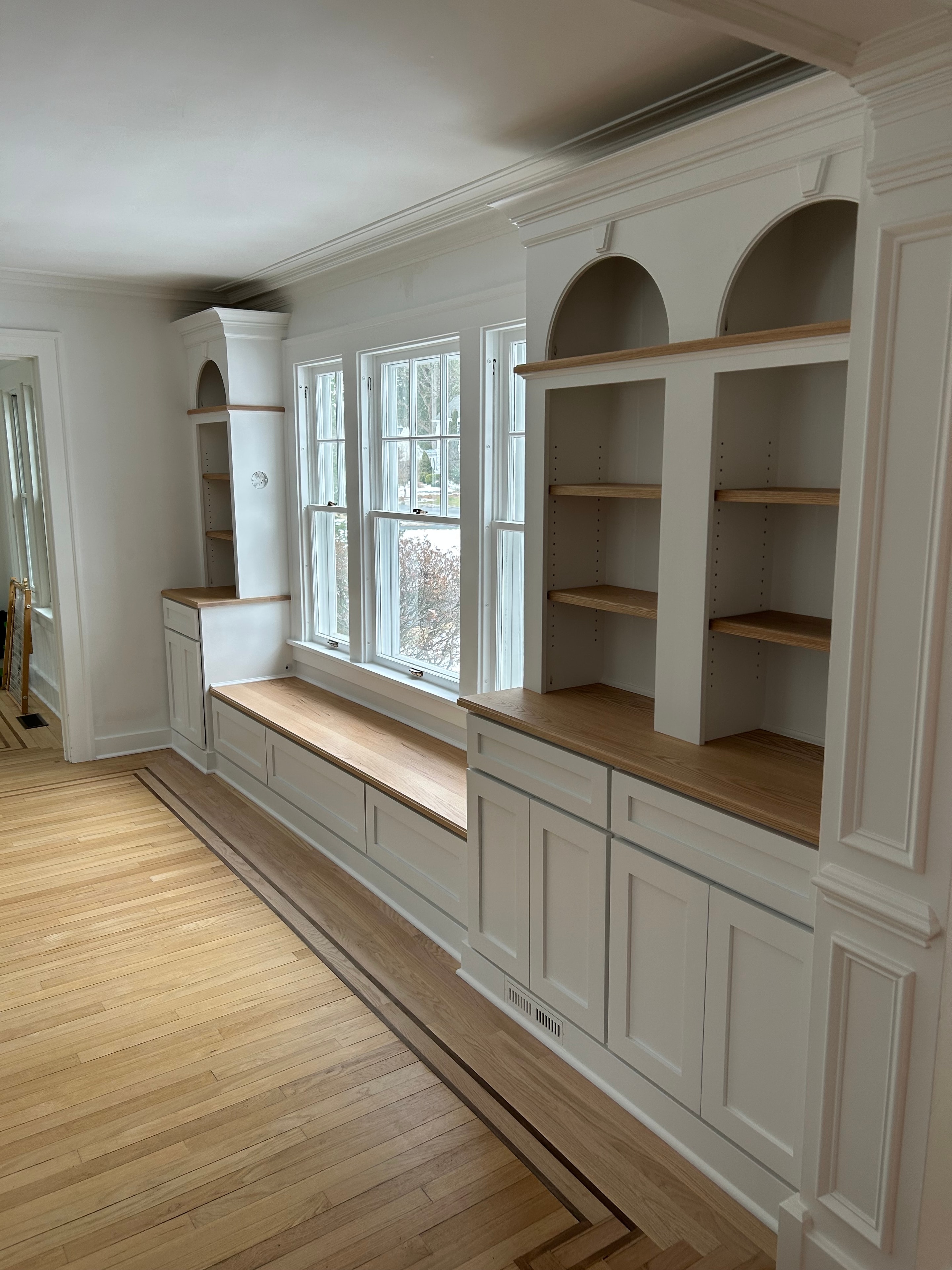 Niskayuna built-in bench - overhead view showing coffered ceiling panels, full wall bookcase towers, arched niches, and window bench below