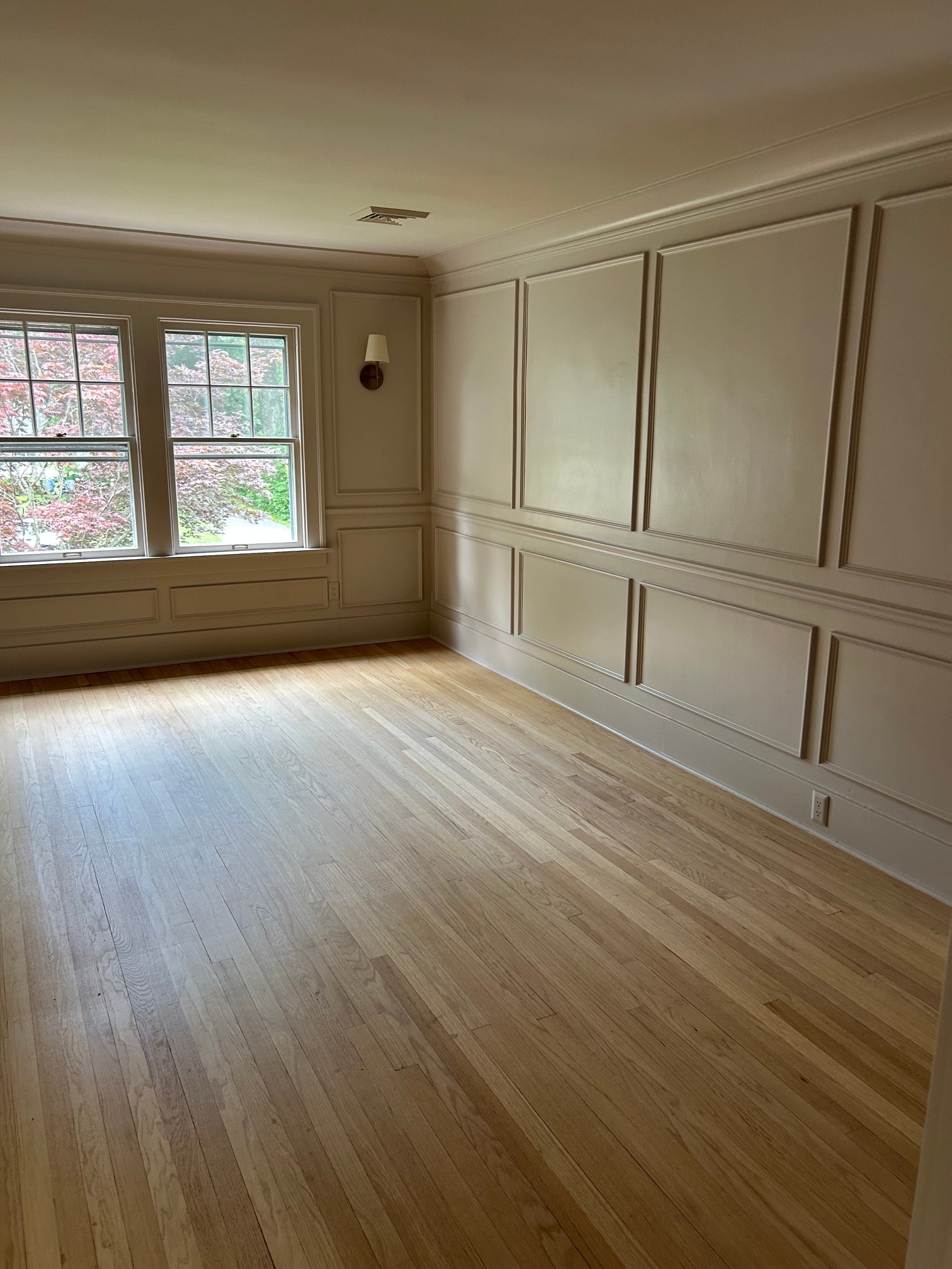 Niskayuna master bedroom coffered ceiling panel grid with crown molding, raised panel wainscoting walls, and natural oak hardwood floor