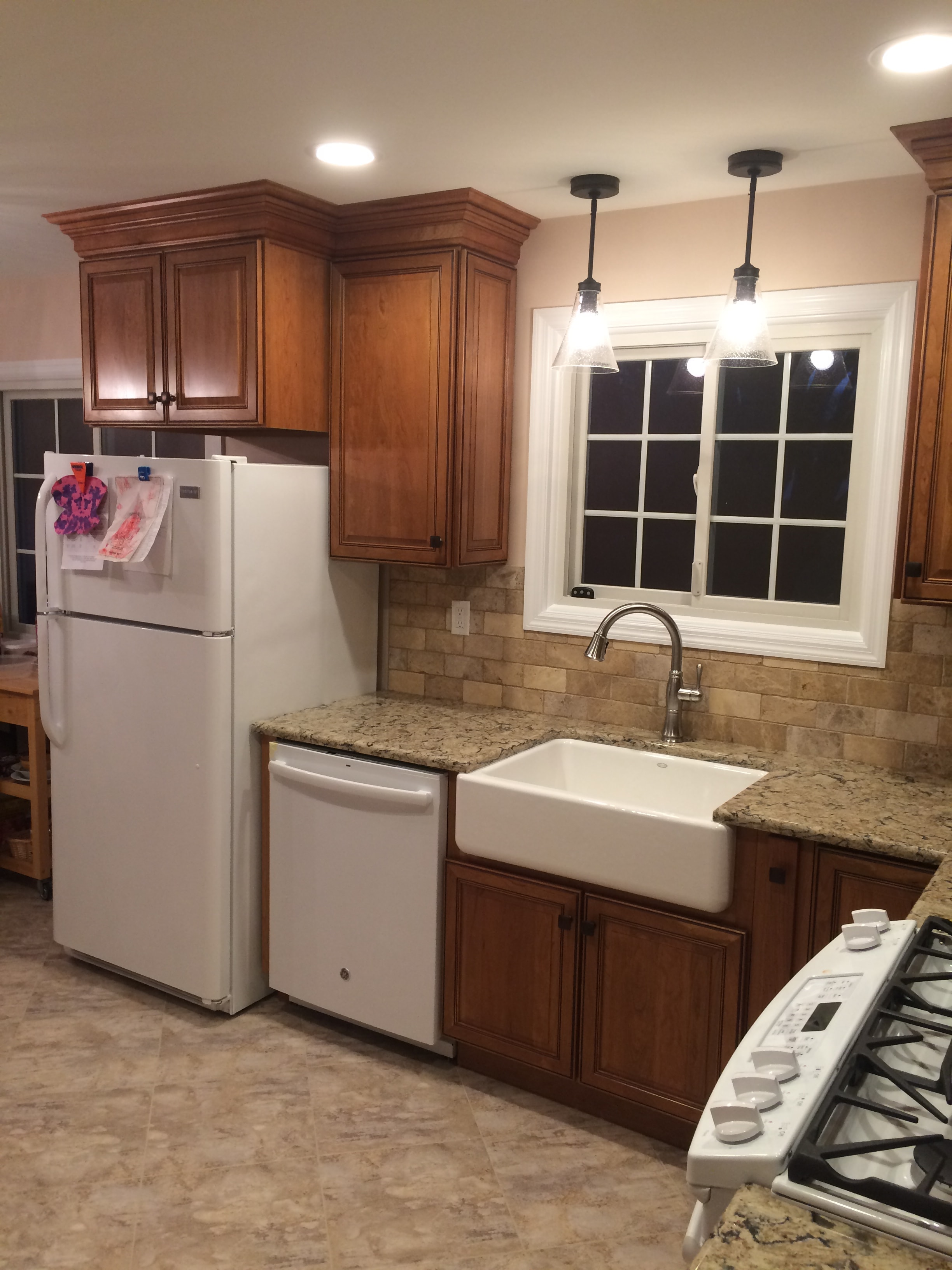 Cherry cabinet kitchen remodel - full overview with warm cherry cabinetry, granite countertops, and white appliances